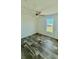 Well-lit bedroom featuring plank flooring, neutral paint, and a ceiling fan at 1377 Ibis Dr, Englewood, FL 34224