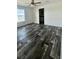 Clean and bright bedroom with plank flooring and large window at 1377 Ibis Dr, Englewood, FL 34224