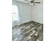 Bright and airy bedroom with plank flooring, white walls, and a ceiling fan at 1377 Ibis Dr, Englewood, FL 34224