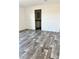 Spacious bedroom with wood-look flooring and access to bathroom at 1377 Ibis Dr, Englewood, FL 34224