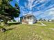 Charming single-Gathering home featuring a covered front porch and a well-manicured lawn under a blue sky at 1377 Ibis Dr, Englewood, FL 34224