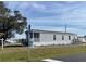 Attractive single story home showcasing tidy landscaping, appealing siding and a welcoming covered porch at 1377 Ibis Dr, Englewood, FL 34224