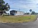 Inviting single story home featuring well-manicured lawn, attractive siding and a covered porch at 1377 Ibis Dr, Englewood, FL 34224