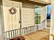 Front entrance with wreath and access to a wooden porch at 1377 Ibis Dr, Englewood, FL 34224