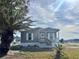 Charming single story home with a covered porch and well-maintained lawn at 1377 Ibis Dr, Englewood, FL 34224