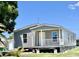 Beautiful single story home with covered porch, showcasing well-maintained yard and attractive siding at 1377 Ibis Dr, Englewood, FL 34224