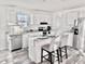 Modern kitchen with white cabinets, granite countertops, and island at 1377 Ibis Dr, Englewood, FL 34224
