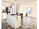 Open concept kitchen with island and view into living area at 1377 Ibis Dr, Englewood, FL 34224