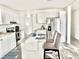 Eat-in kitchen with white cabinets, granite countertops and island at 1377 Ibis Dr, Englewood, FL 34224