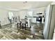 Eat-in kitchen features stainless appliances, white cabinets, and stone countertops at 1377 Ibis Dr, Englewood, FL 34224