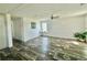 Spacious living room featuring plank flooring, neutral walls, and natural light at 1377 Ibis Dr, Englewood, FL 34224