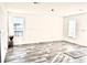 Bright and airy living room with wood-look floors and large windows at 1377 Ibis Dr, Englewood, FL 34224