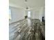 Bright open living space featuring plank floors, neutral paint, and natural light at 1377 Ibis Dr, Englewood, FL 34224