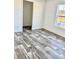 Bright living room with wood-look floors and large window at 1377 Ibis Dr, Englewood, FL 34224