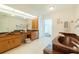 Bathroom featuring double sinks, marble tub, and a shower with natural lighting at 3440 Downing W St, Englewood, FL 34224