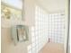 Bright bathroom with a glass brick shower and a window offering natural light at 3440 Downing W St, Englewood, FL 34224