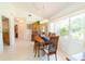Dining room with wood table and chairs, built-in hutch, and bright natural light at 3440 Downing W St, Englewood, FL 34224
