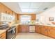 Bright kitchen with stainless steel appliances, light cabinetry, and ample counter space at 3440 Downing W St, Englewood, FL 34224