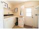 Functional laundry room with washer, dryer, and storage shelves at 3440 Downing W St, Englewood, FL 34224