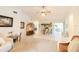 Open-concept living area with bar seating and access to the kitchen and outdoor patio at 3440 Downing W St, Englewood, FL 34224