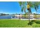 Lush green lawn with canal views and private dock access at 42 Waterford Dr, Englewood, FL 34223