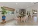 Bright dining room with glass-top table and wicker chairs at 42 Waterford Dr, Englewood, FL 34223