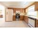 View of kitchen with stainless steel appliances and white refrigerator at 3440 Downing W St, Englewood, FL 34224