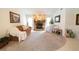 Living room with stone fireplace, neutral carpet, and comfy seating at 3440 Downing W St, Englewood, FL 34224