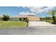 Single-story home with attached garage and well-maintained lawn at 3440 Downing W St, Englewood, FL 34224