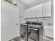 Laundry room with washer, dryer, and cabinets at 3275 Osprey Ln, Port Charlotte, FL 33953