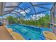 Inviting screened pool with a tranquil and lush natural backdrop at 3275 Osprey Ln, Port Charlotte, FL 33953