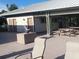Outdoor patio area with picnic tables, chairs, and dolphin statue at 3275 Osprey Ln, Port Charlotte, FL 33953