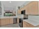 Modern kitchen with stainless steel appliances and light wood cabinets at 3275 Osprey Ln, Port Charlotte, FL 33953