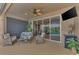 Relaxing pool patio with wicker furniture and sliding glass doors leading to the pool area at 3275 Osprey Ln, Port Charlotte, FL 33953
