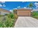 Tan house with a landscaped yard and a two-car garage at 3275 Osprey Ln, Port Charlotte, FL 33953