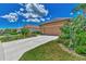Landscaped front yard with a two-car garage at 3275 Osprey Ln, Port Charlotte, FL 33953