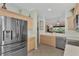 Modern kitchen with stainless steel appliances and light wood cabinets at 3275 Osprey Ln, Port Charlotte, FL 33953