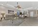 Open living room with gray couches, a coffee table and views into other rooms at 3275 Osprey Ln, Port Charlotte, FL 33953