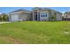 Single-Gathering home with a two-car garage and a manicured lawn at 8111 Arlewood Cir, Port Charlotte, FL 33981