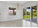 Bright dining room with hardwood floors and sliding glass doors to backyard at 8111 Arlewood Cir, Port Charlotte, FL 33981