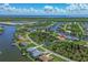 Aerial view of a waterfront community with single Gathering homes and lush landscaping at 8111 Arlewood Cir, Port Charlotte, FL 33981