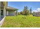 Landscaped backyard with grassy lawn and shed at 8111 Arlewood Cir, Port Charlotte, FL 33981