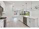Modern kitchen with white cabinets, quartz countertops, and stainless steel appliances at 8111 Arlewood Cir, Port Charlotte, FL 33981
