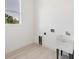 Laundry room with utility sink and light flooring at 8111 Arlewood Cir, Port Charlotte, FL 33981