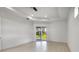 Bright bedroom with hardwood floors and sliding glass doors to backyard at 8111 Arlewood Cir, Port Charlotte, FL 33981