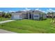 Single-Gathering home with a two-car garage and a manicured lawn at 8111 Arlewood Cir, Port Charlotte, FL 33981
