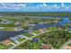Aerial view of a waterfront community, showcasing houses, canals, and lush greenery at 8111 Arlewood Cir, Port Charlotte, FL 33981