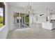 Open concept dining room with hardwood floors and views to the kitchen and backyard at 8111 Arlewood Cir, Port Charlotte, FL 33981