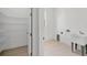Laundry room with utility sink, shelving, and light flooring at 8111 Arlewood Cir, Port Charlotte, FL 33981