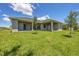 House backyard with grassy lawn at 8111 Arlewood Cir, Port Charlotte, FL 33981